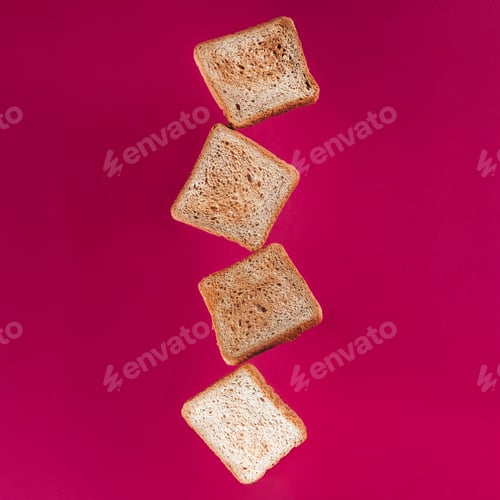 Preview: close up view of levitating toasts isolated on pink