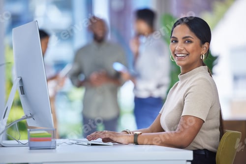 Preview: Portrait of a young businesswoman working on a computer in an office
