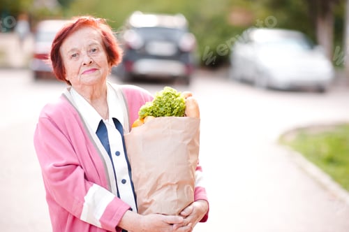 Preview: Smiling senior woman with food outdoor