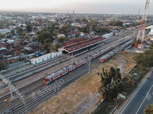 Preview: Aerial view of train station in sunset near road in Indonesia.