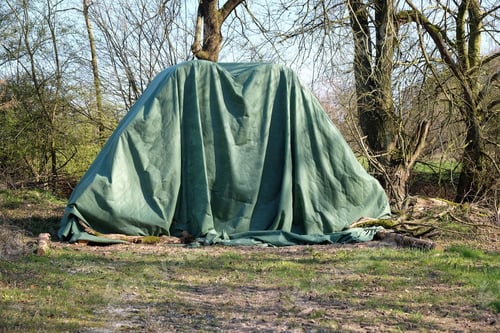Preview: Closeup of hay bales covered with a protective tarp; hay storage