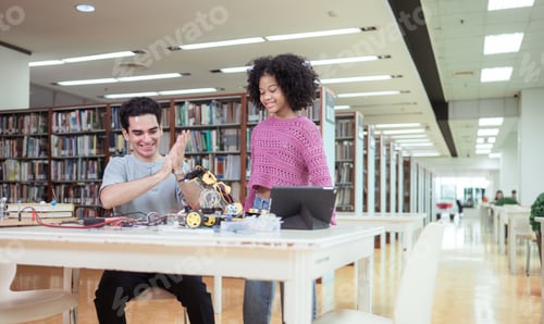 Preview: A teacher guiding students in a robotics project during a STEM class in the library