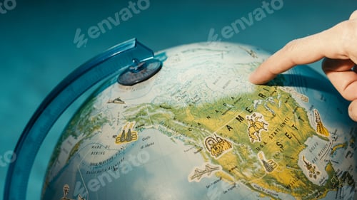 Preview: Finger pointing on globe