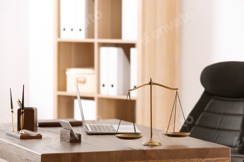 Preview: Table with scales of justice in lawyer's office
