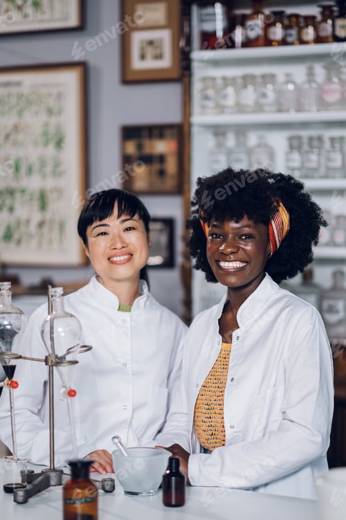 Preview: Two multicultural pharmacists standing in a vintage pharmacy