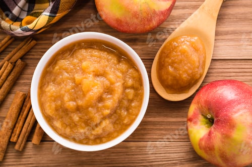 Preview: Apple puree, apples and cinnamon on a wooden table. Top View