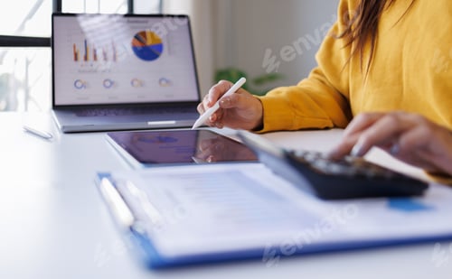 Preview: Businesswoman working and calculating on digital financial