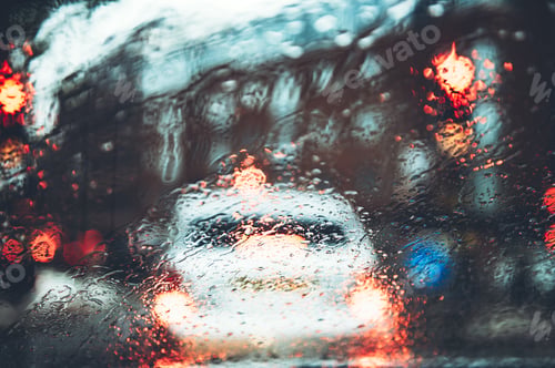 Preview: Blurred city street during dark rainy day