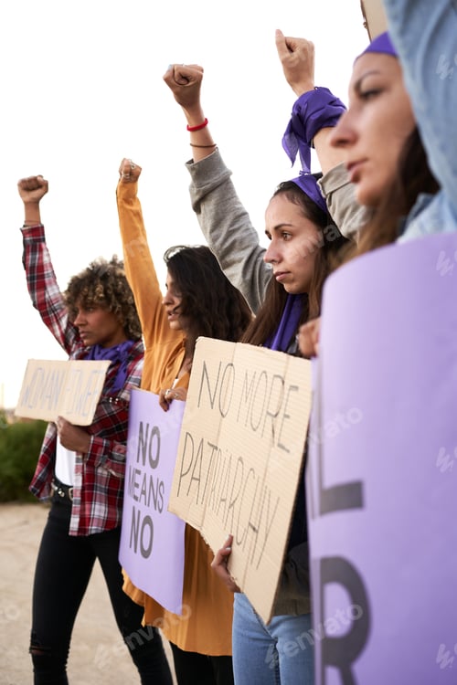 Preview: Vertical photo of a group of women marching on the road in protest
