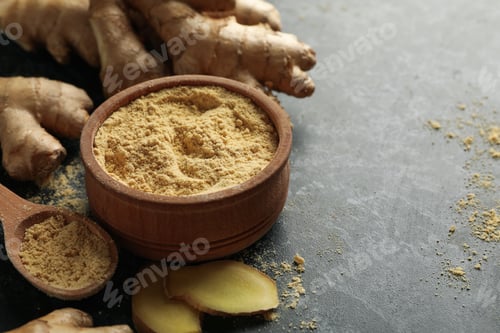Preview: Ginger and bowl with ginger powder on black smoky background