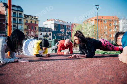 Preview: Calisthenics class in park, males and females doing push ups
