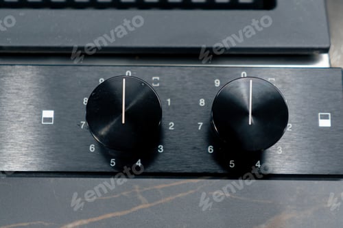 Preview: close-up of a professional kitchen with a metal part of the oven with temperature and time switches