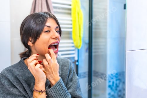 Preview: Woman placing transparent brackets in the toilet