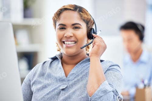 Preview: Closeup of smiling mixed race female call center agent talking on headset. Business woman or transl