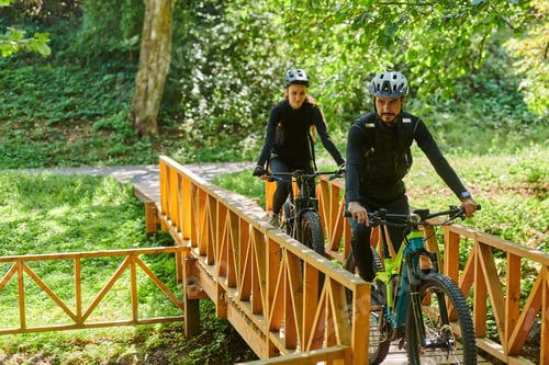 Preview: A blissful couple, adorned in professional cycling gear, enjoys a romantic bicycle ride through a