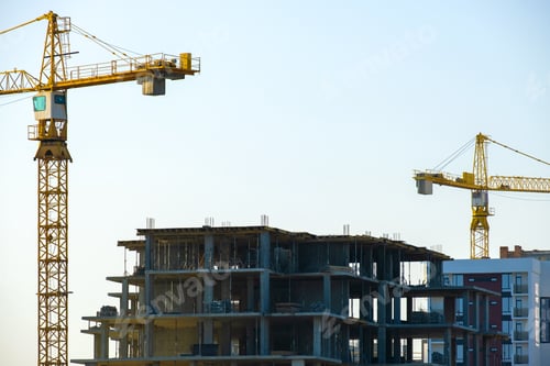 Preview: Aerial view of tower cranes and high residential apartment buildings under construction. Real estate