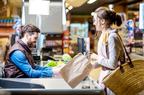 Preview: Woman customer with cashier in the supermarket