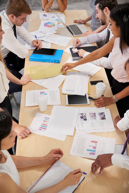 Preview: Business group brainstorming at a table, elevated close up