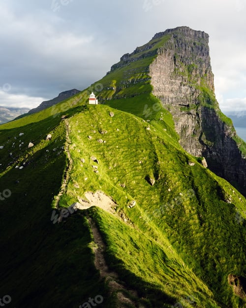 Preview: Kallur lighthouse on green hills of Kalsoy island