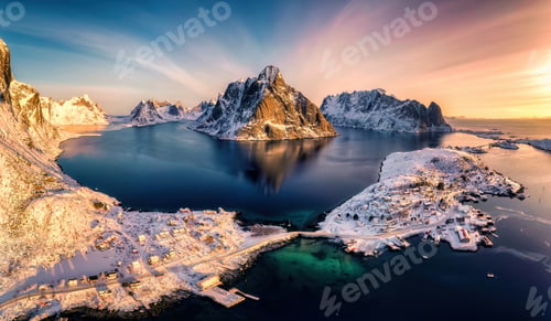 Preview: Colorful sunrise over Lofoten Islands and traditional norwegian fishing village in winter at Norway