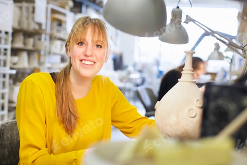 Preview: Female potter working in ceramic workshop