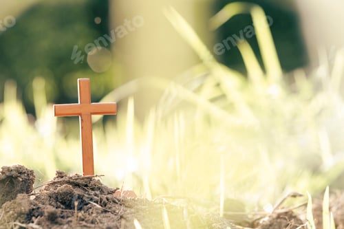 Preview: Cross on blurry sunset background.