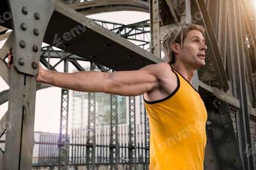 Preview: Man stretching on bridge, Munich, Bavaria, Germany