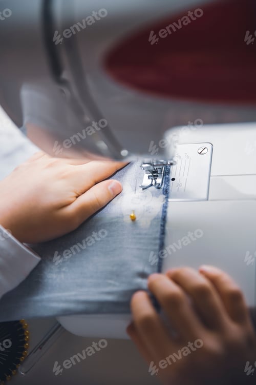 Preview: young girl working with sewing machine