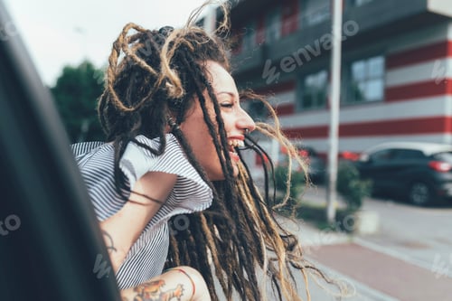 Preview: Woman leaning out of car window