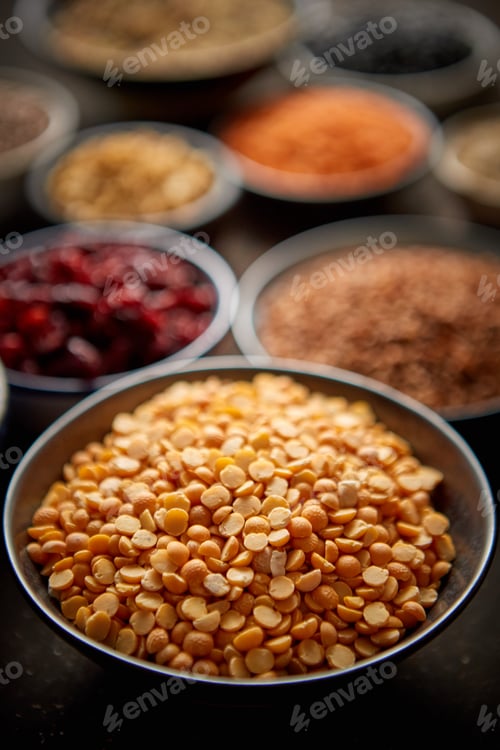 Preview: Raw peas halfs seeds in ceramic bowl. Selective focus
