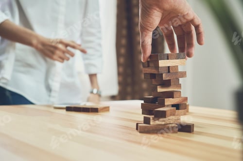 Preview: women and teamwork making a pyramid with empty wooden cubes
