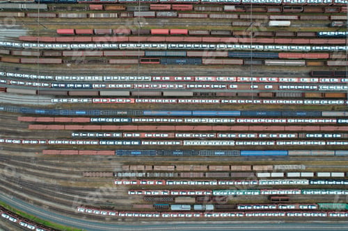 Preview: Aerial view of a train yard with multiple railway lines, with cars on top