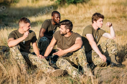 Preview: multiracial young soldiers in military uniform resting on range