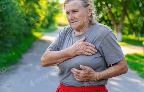 Preview: grandmother hurts heart on the road. Selective focus.