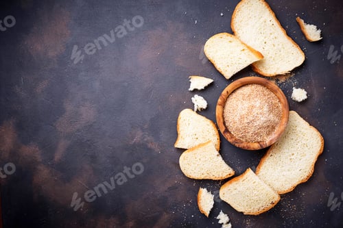 Preview: Bowl of breadcrumbs and slices of a loaf