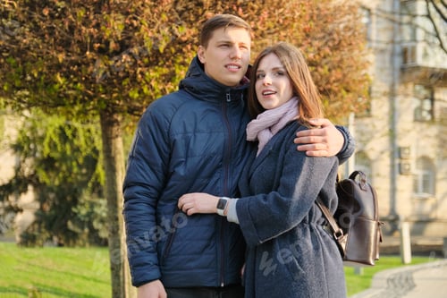 Preview: Portrait of beautiful couple in city, happy young man and woman embracing, golden hour