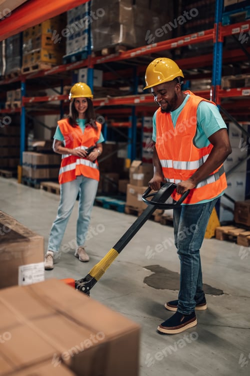 Preview: Warehouse workers managing inventory with hand pallet truck and scanner