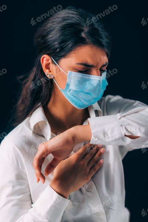Preview: Covid-19 Coronavirus Prevention. Beautiful Young Woman Coughing in her Elbow or Sleeve
