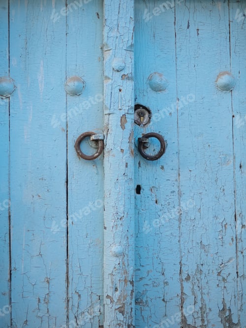 Preview: Aged wooden door in metal rivets