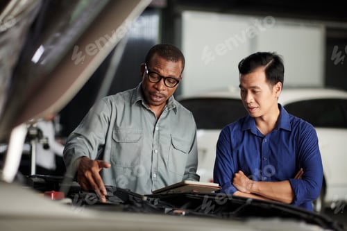 Preview: Mechanic Examining Car Engine
