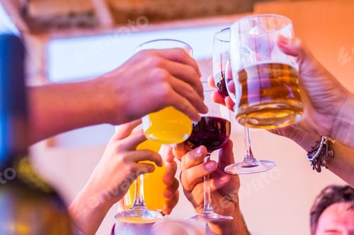 Preview: Clinking glasses above dinner table. Hands of people with glasses. Celebrating and toasting