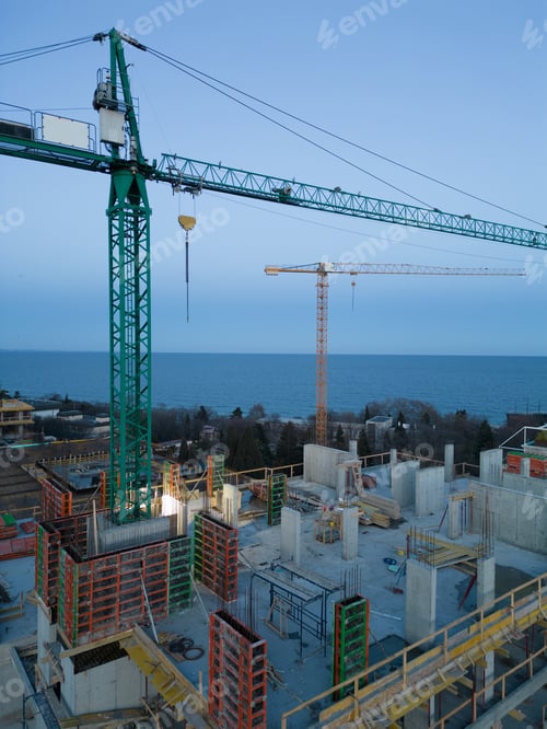Preview: Busy Construction Site and Construction Equipment at night. Aerial view