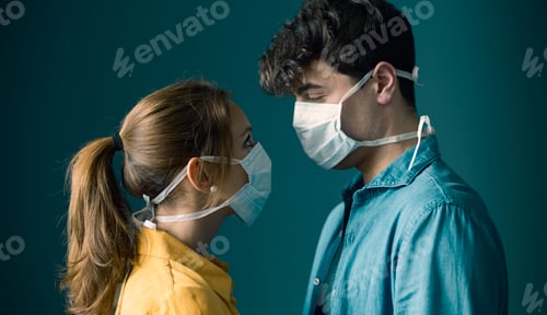 Preview: Young couple wearing a protective face mask