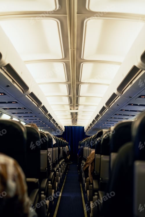 Preview: Ready to take to the sky. Rearview shot of unidentifiable passengers seated in an airplane cabin.