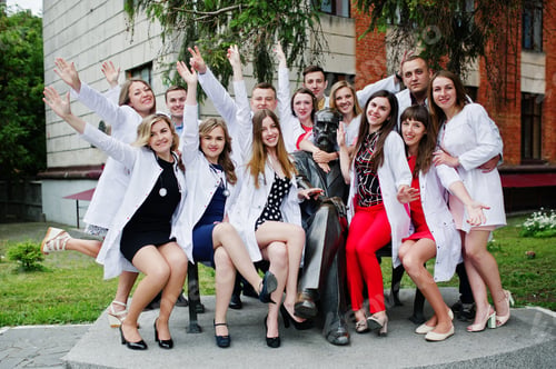 Preview: Cool young doctors or medical workers posing outside the hospital or clinique.