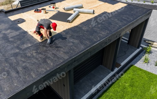 Preview: Construction Worker Applying EPDM Roofing Material on Modern House During Daytime