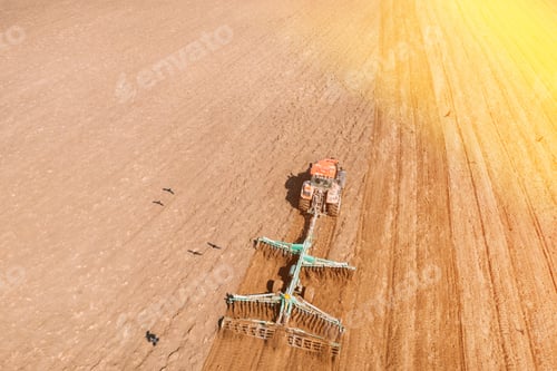 Preview: Top View Tractor Plowing Field In Spring Season. Beginning Of Agricultural Spring Season. Cultivator