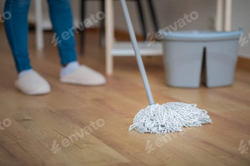 Preview: Cropped of woman mopping floor in room