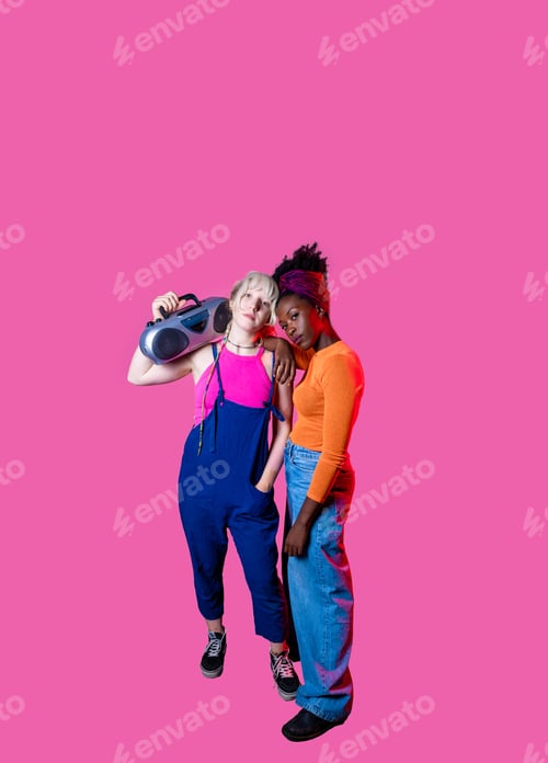 Preview: Two young diverse women holding boombox posing confident isolated copyspace advertising background
