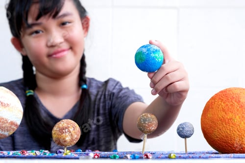 Preview: girl hand holding earth planet with blurred background